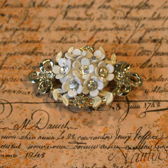 This unusual brooch features a cluster of white flowers filled with diam... click for more information